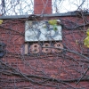 <p>Building number and construction date above main entrance in center tower, Barracks (Building 55), looking southeast, December 2005.</p>